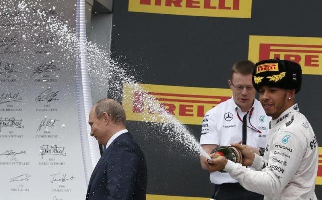 Russian President Putin leaves podium while Mercede's Hamiliron celebrates winning Russian F1 Grand Prix in Sochi